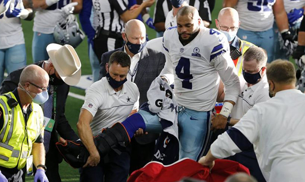 Dallas Cowboys quarterback Dak Prescott (4) is assisted by first responders and team medical staff ...