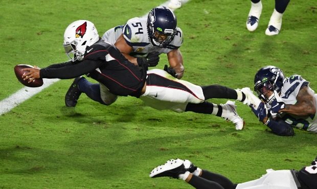 Kyler Murray #1 of the Arizona Cardinals dives into the end zone for a touchdown while avoiding tac...