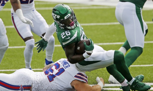 New York Jets running back Le'Veon Bell (26) is brought down by Buffalo Bills' Justin Zimmer (61) d...