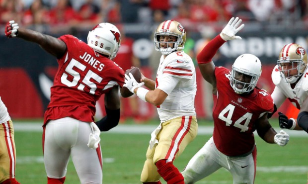 San Francisco 49ers quarterback Brian Hoyer looks to throw as Arizona Cardinals outside linebacker ...