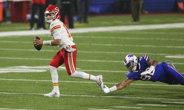 Kansas City Chiefs quarterback Patrick Mahomes, left, outruns Buffalo Bills' Darryl Johnson during ...