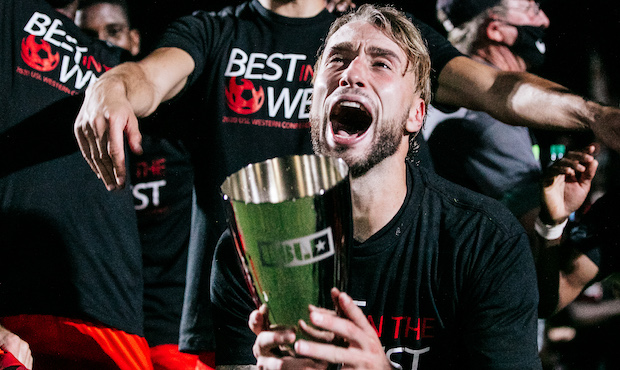 Phoenix Rising FC center back Joey Farrell celebrates with the 2020 Western Conference Final trophy...