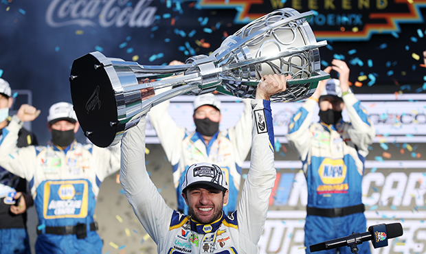 Chase Elliott, driver of the #9 NAPA Auto Parts Chevrolet, celebrates in victory lane after winning...