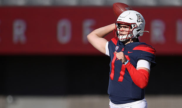 Quarterback Grant Gunnell #17 of the Arizona Wildcats throws a pass during the first half of the Pa...