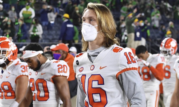 Clemson quarterback Trevor Lawrence (16) leaves the field with his teammates after Clemson lost to ...