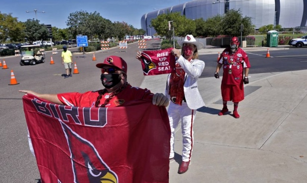 Arizona Cardinals fans cheer outside State Farm Stadium as teams arrive prior to an NFL football ga...