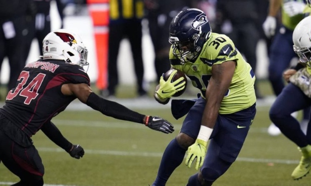 Seattle Seahawks running back Carlos Hyde (30) rushes as Arizona Cardinals free safety Jalen Thomps...