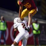Southern California wide receiver Drake London (15) hurdles over Arizona State defensive back DeAndre Pierce (2) during the first half of an NCAA college football game Saturday, Nov. 7, 2020, in Los Angeles. (AP Photo/Ashley Landis)