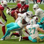 Miami Dolphins running back Jordan Howard, center, scores a touchdown against the Arizona Cardinals during the first half of an NFL football game, Sunday, Nov. 8, 2020, in Glendale, Ariz. (AP Photo/Rick Scuteri)