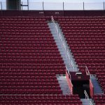A man stands alone in the upper part of the stands during the second half of an NCAA college football game between Southern California and Arizona State, Saturday, Nov. 7, 2020, in Los Angeles. (AP Photo/Ashley Landis)