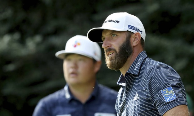 Dustin Johnson, right, reacts after teeing off on the 14th hole next to Sungjae Im during the final...