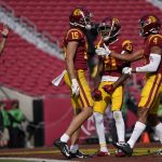 Southern California wide receiver Drake London (15) celebrates with teammates Tyler Vaughns (21) and Bru McCoy (4) after catching a pass in the end zone for a touchdown against Arizona State during an NCAA football game Saturday, Nov. 7, 2020, in Los Angeles. USC won 28-27. (AP Photo/Ashley Landis)