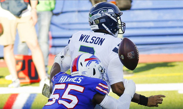 Buffalo Bills' Jerry Hughes (55) knocks the ball away from Seattle Seahawks' Russell Wilson (3) to ...