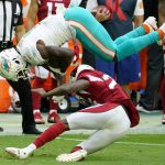 Miami Dolphins wide receiver DeVante Parker is upended by Arizona Cardinals cornerback De'Vante Bausby, right, during the first half of an NFL football game, Sunday, Nov. 8, 2020, in Glendale, Ariz. (AP Photo/Rick Scuteri)