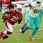 Arizona Cardinals running back Chase Edmonds (29) runs the ball as Miami Dolphins defensive end Shaq Lawson (90) pursues during the first half of an NFL football game, Sunday, Nov. 8, 2020, in Glendale, Ariz. (AP Photo/Rick Scuteri)
