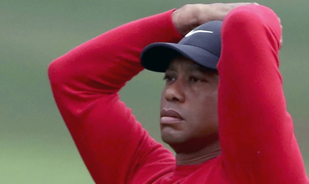 Tiger Woods reacts after his shot on the second hole during the final round of the Masters golf tou...
