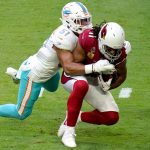 Arizona Cardinals wide receiver Larry Fitzgerald (11) makes the catch as Miami Dolphins outside linebacker Kamu Grugier-Hill (51) makes the tackle during the first half of an NFL football game, Sunday, Nov. 8, 2020, in Glendale, Ariz. (AP Photo/Ross D. Franklin)