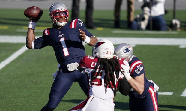New England Patriots quarterback Cam Newton, left, passes under pressure from Arizona Cardinals lin...