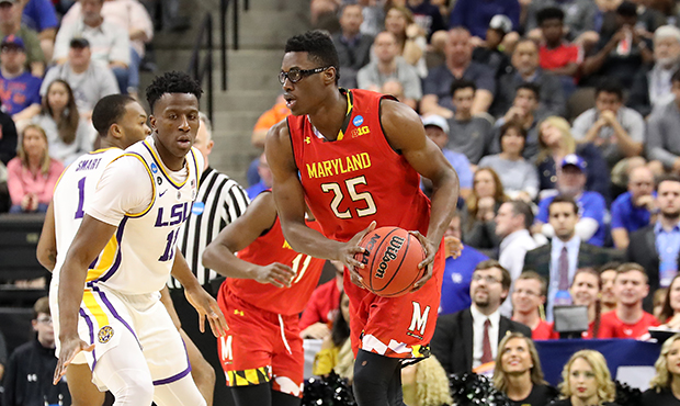Jalen Smith #25 of the Maryland Terrapins drives against Kavell Bigby-Williams #11 of the LSU Tiger...