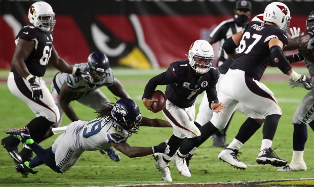Quarterback Kyler Murray #1 of the Arizona Cardinals scrambles with the football against the Seattl...