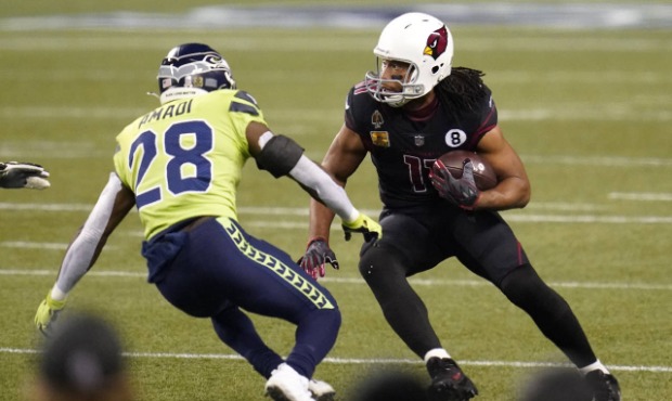 Arizona Cardinals wide receiver Larry Fitzgerald, right, tries to get around Seattle Seahawks safet...