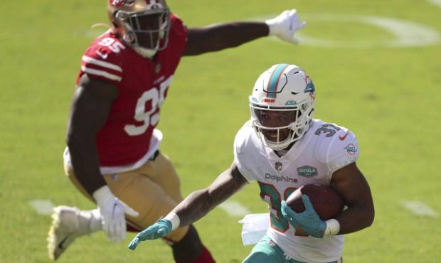 Miami Dolphins running back Myles Gaskin (37) runs in front of San Francisco 49ers defensive end Ke...