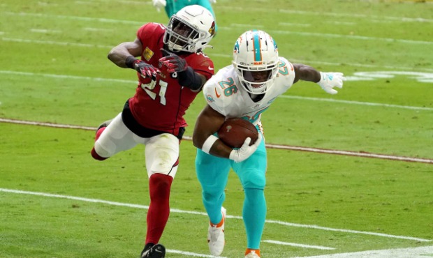 Miami Dolphins running back Salvon Ahmed (26) is knocked out of bounds by Arizona Cardinals cornerb...