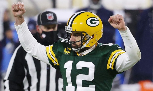 Quarterback Aaron Rodgers #12 of the Green Bay Packers celebrates a touchdown against the Tennessee...