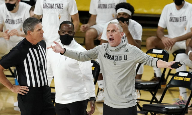 Arizona State coach Bobby Hurley, right argues with a referee as Arizona State associated head coac...