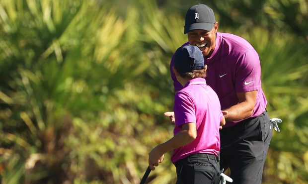 ORLANDO, FLORIDA - DECEMBER 19: Tiger Woods of the United States and Charlie Woods react on the thi...