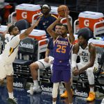 Phoenix Suns forward Mikal Bridges (25) shoots as Utah Jazz forward Juwan Morgan, left, defends during the first half of an NBA preseason basketball game Saturday, Dec. 12, 2020, in Salt Lake City. (AP Photo/Rick Bowmer)