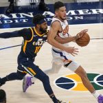 Phoenix Suns guard Devin Booker drives to the basket as Utah Jazz guard Mike Conley (10) defends during the second half of an NBA basketball game Thursday, Dec. 31, 2020, in Salt Lake City. (AP Photo/Rick Bowmer)