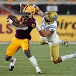 Arizona State running back Rachaad White, left, is tackled by UCLA linebacker Bo Calvert, right, during the second half of an NCAA college football game, Saturday, Dec. 5, 2020, in Tempe, Ariz. UCLA won 25-18. (AP Photo/Matt York)