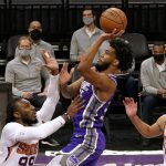 Sacramento Kings forward Marvin Bagley III goes to the basket against Phoenix Suns forward Jae Crowder, left, during the first quarter of an NBA basketball game in Sacramento, Calif., Saturday, Dec. 26, 2020. (AP Photo/Rich Pedroncelli)