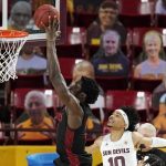 San Diego State forward Nathan Mensah, left, goes in for a dunk as he gets past Arizona State guard Jaelen House (10) during the first half of an NCAA college basketball game Thursday, Dec. 10, 2020, in Tempe, Ariz. (AP Photo/Ross D. Franklin)