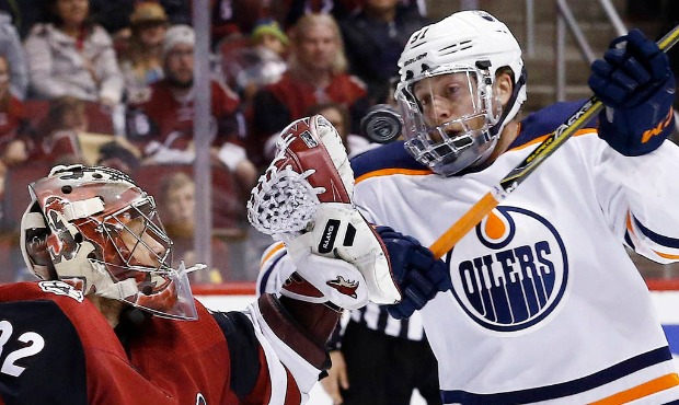 Arizona Coyotes goaltender Antti Raanta (32) reaches out to catch the puck as it gets by Edmonton O...