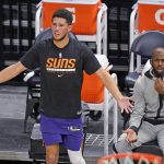 Phoenix Suns guard Devin Booker (1) and teammate Chris Paul react to a call during the second half of the team's NBA preseason basketball game against the Utah Jazz on Saturday, Dec. 12, 2020, in Salt Lake City. (AP Photo/Rick Bowmer)