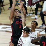 San Diego State forward Matt Mitchell (11) shoots over Arizona State forward Jalen Graham (24) and guard Alonzo Verge Jr., right, during the second half of an NCAA college basketball game Thursday, Dec. 10, 2020, in Tempe, Ariz. (AP Photo/Ross D. Franklin)