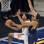 Phoenix Suns guard Cameron Payne, left, goes to the basket as Utah Jazz center Rudy Gobert, right, defends during the first half of an NBA basketball game Thursday, Dec. 31, 2020, in Salt Lake City. (AP Photo/Rick Bowmer)