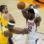 Los Angeles Lakers forward Marc Gasol fouls Phoenix Suns center Deandre Ayton (22) during the second half of a preseason NBA basketball game, Friday, Dec. 18, 2020, in Phoenix, Ariz. (AP Photo/Matt York)