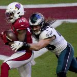 Arizona Cardinals running back Chase Edmonds (29) scores a touchdown as Philadelphia Eagles linebacker Alex Singleton defends during the first half of an NFL football game, Sunday, Dec. 20, 2020, in Glendale, Ariz. (AP Photo/Ross D. Franklin)