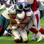 Arizona Cardinals wide receiver Larry Fitzgerald is tackled by Philadelphia Eagles strong safety Jalen Mills (21) and defensive end Genard Avery (58) during the first half of an NFL football game, Sunday, Dec. 20, 2020, in Glendale, Ariz. (AP Photo/Rick Scuteri)