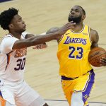 Phoenix Suns center Damian Jones (30) defends against Los Angeles Lakers forward LeBron James (23) during the first half of a preseason basketball game, Friday, Dec. 18, 2020, in Phoenix, Ariz. (AP Photo/Matt York)