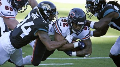 Chicago Bears running back David Montgomery (32) runs for an 8-yard gain as he is tackled by Jackso...