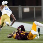 UCLA defensive back Obi Eboh (22) breaks up a pass intended for Arizona State wide receiver Johnny Wilson (14) during the first half of an NCAA college football game Saturday, Dec. 5, 2020, in Tempe, Ariz. (AP Photo/Matt York)