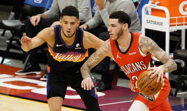 New Orleans Pelicans guard Lonzo Ball (2) drives on Phoenix Suns guard Devin Booker during the firs...
