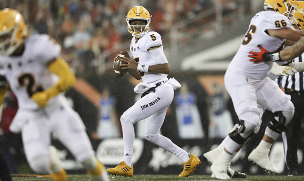 Arizona State quarterback Jayden Daniels (5) drops back to pass during the first half of an NCAA co...
