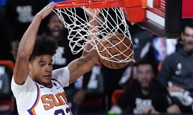 Phoenix Suns forward Cameron Johnson (23) slams home a dunk during the second half of an NBA basket...