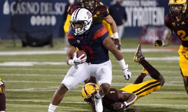 Arizona running back Gary Brightwell (0) runs the ball against Arizona State in the first half of a...