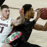 San Diego State forward Joshua Tomaic, right, controls the ball on the floor after beating Arizona State forward Chris Osten (21) to the ball during the first half of an NCAA college basketball game Thursday, Dec. 10, 2020, in Tempe, Ariz. (AP Photo/Ross D. Franklin)
